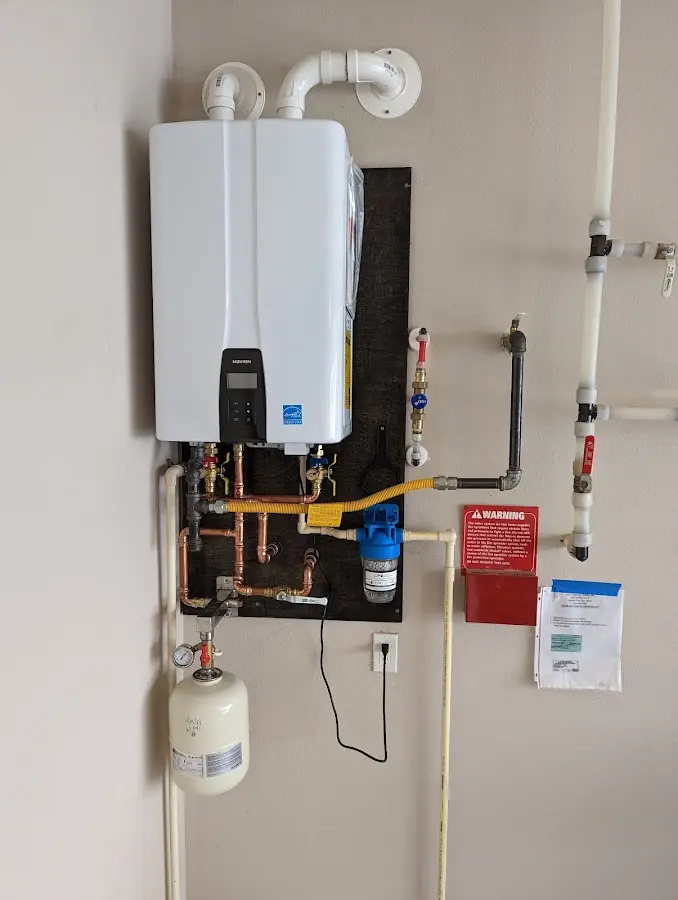 Professional plumber installing copper piping in a Commercial home